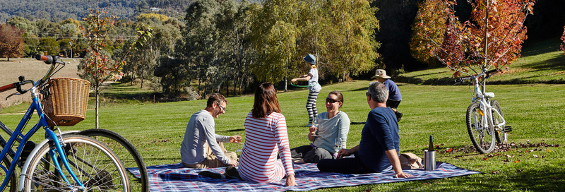 Customers enjoying a relaxed BYO picnic and a glass of RInger Reef Wine on the lawns at Ringer Reef winery. Stunning views of Mount Buffalo, Buckland Valley and the vineyard make for a very relaxing afternoon. Kid friendly too